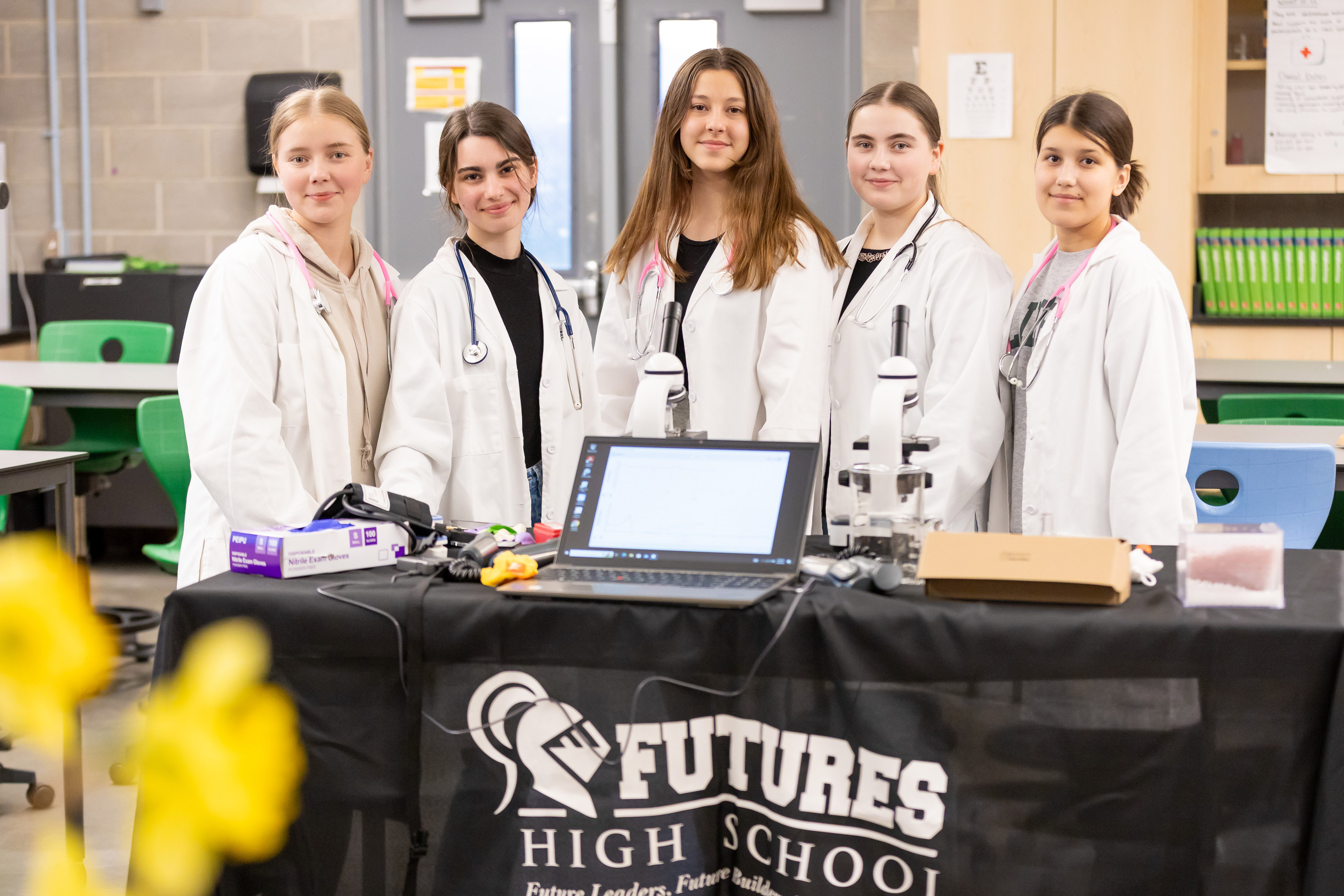 Five students behind table