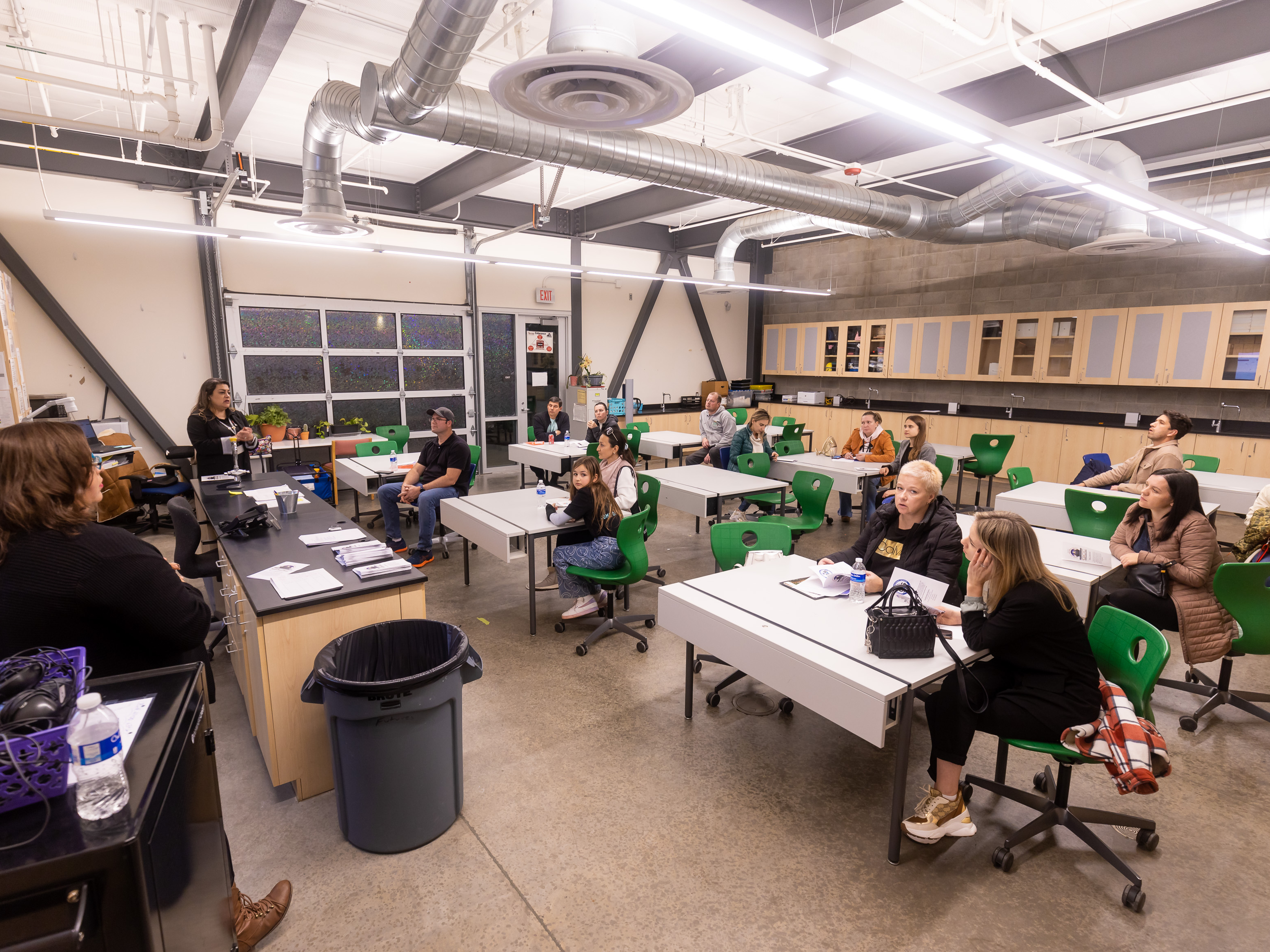 Parents sitting in classroom listening to presentation