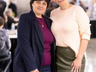 Two staff members are posed for a picture