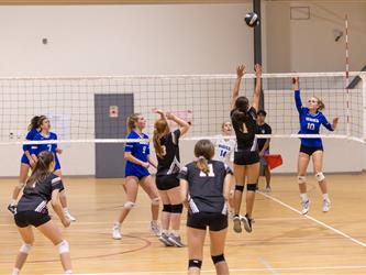 Volleyball game hitting ball over net