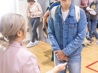 Student speaking with staff