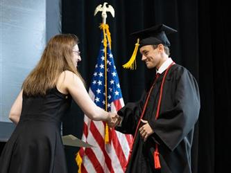 Graduate shaking hands