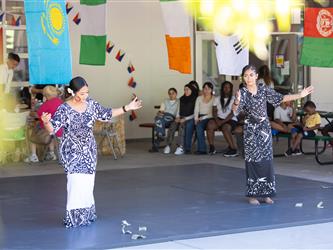 2 students doing traditional dance in cultural dresses