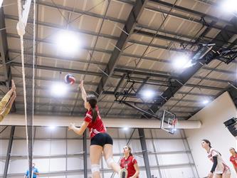 Futures Girls Volleyball team spiking