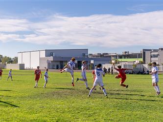 Student leaping to head ball