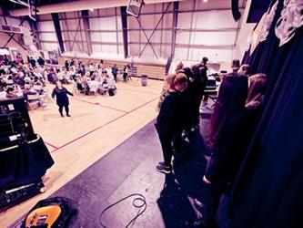 View of audience watching singers on stage
