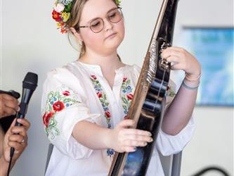 Student doing traditional dance in white dress