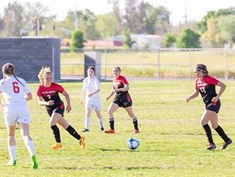 Soccer players in field