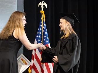 Graduate shaking hands