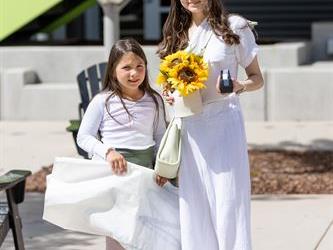 Woman and young girl with yellow flower