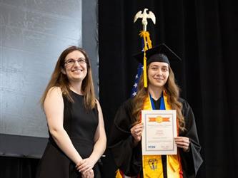 Student posing with certificate