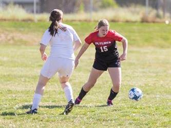 Soccer players playing soccer
