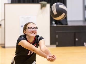 Girl hitting ball