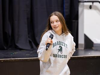Student speaking into mic