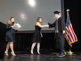 Student receiving award and shaking hands