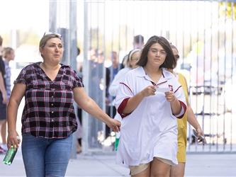 Students and staff walking in hall