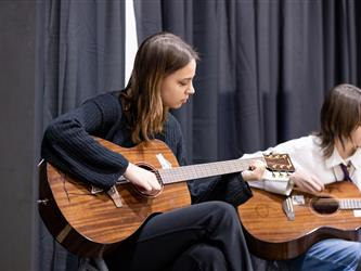 Student playing guitar