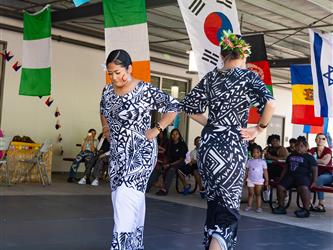 2 students doing traditional dance in cultural dresses