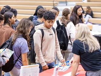 Students reviewing recruitment tables