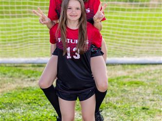 Girls soccer team players posing