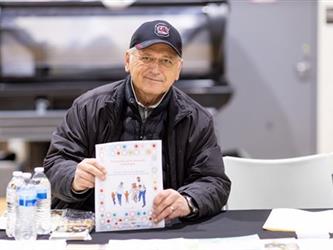 Staff handing out information at table