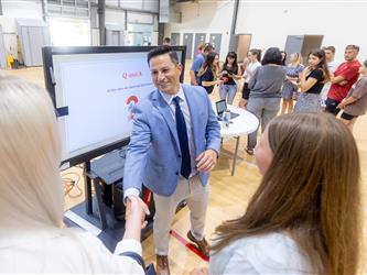 Students and families talking to teachers
