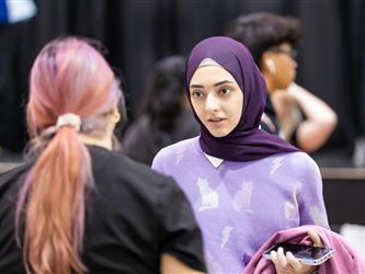Students reviewing materials and speaking with recruiters