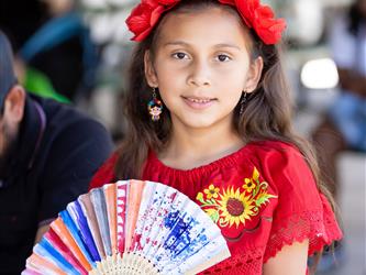 Students helping children with craft activity 