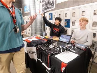 Two student wrestlers are displaying their table