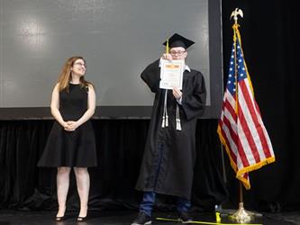 Student showing off certificate/award