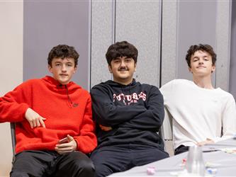 3 students sitting in chairs