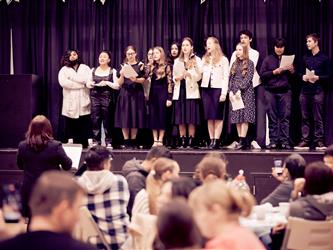 Students singing on stage