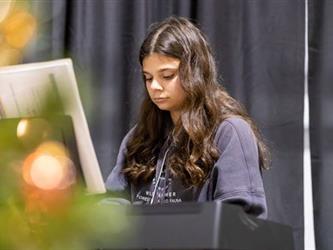 Student playing piano