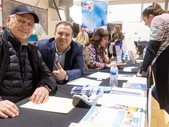 Volunteers posing for camera at table