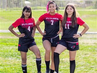 Girls soccer team players posing