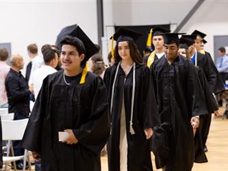 Students walking into gym in a line
