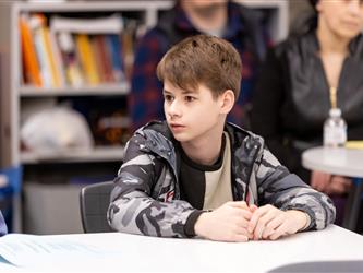 A student is focused on something to his right