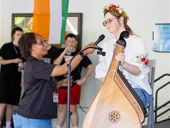 Student doing traditional dance in white dress
