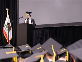 Grad speaking at mic