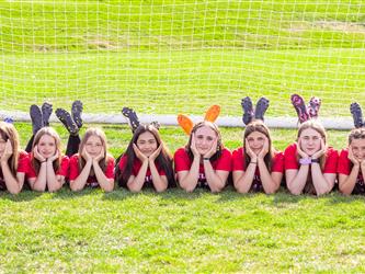 Girls soccer team posing