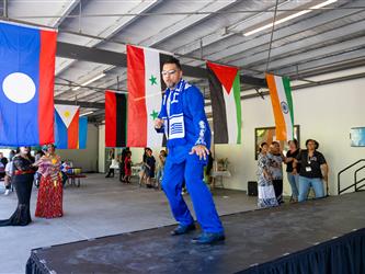 2 students on stage in cultural attire 