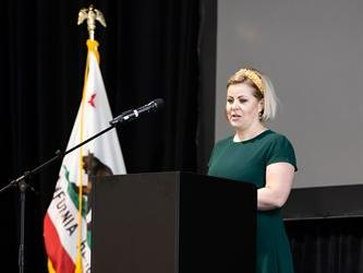 Woman at podium on stage