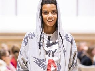Student in hoodie smiling
