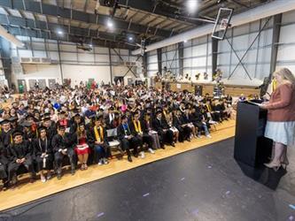 Superintendent speaking at podium with audience