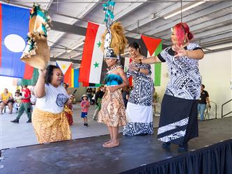 Staff member on stage in cultural attire 