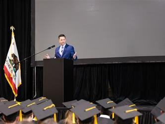 Principal speaking on stage