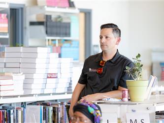 Man leaning on bookshelf