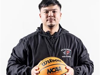 Futures Varsity Basketball coach holding ball