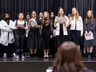 Students singing on stage