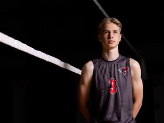 Volleyball player posing by net